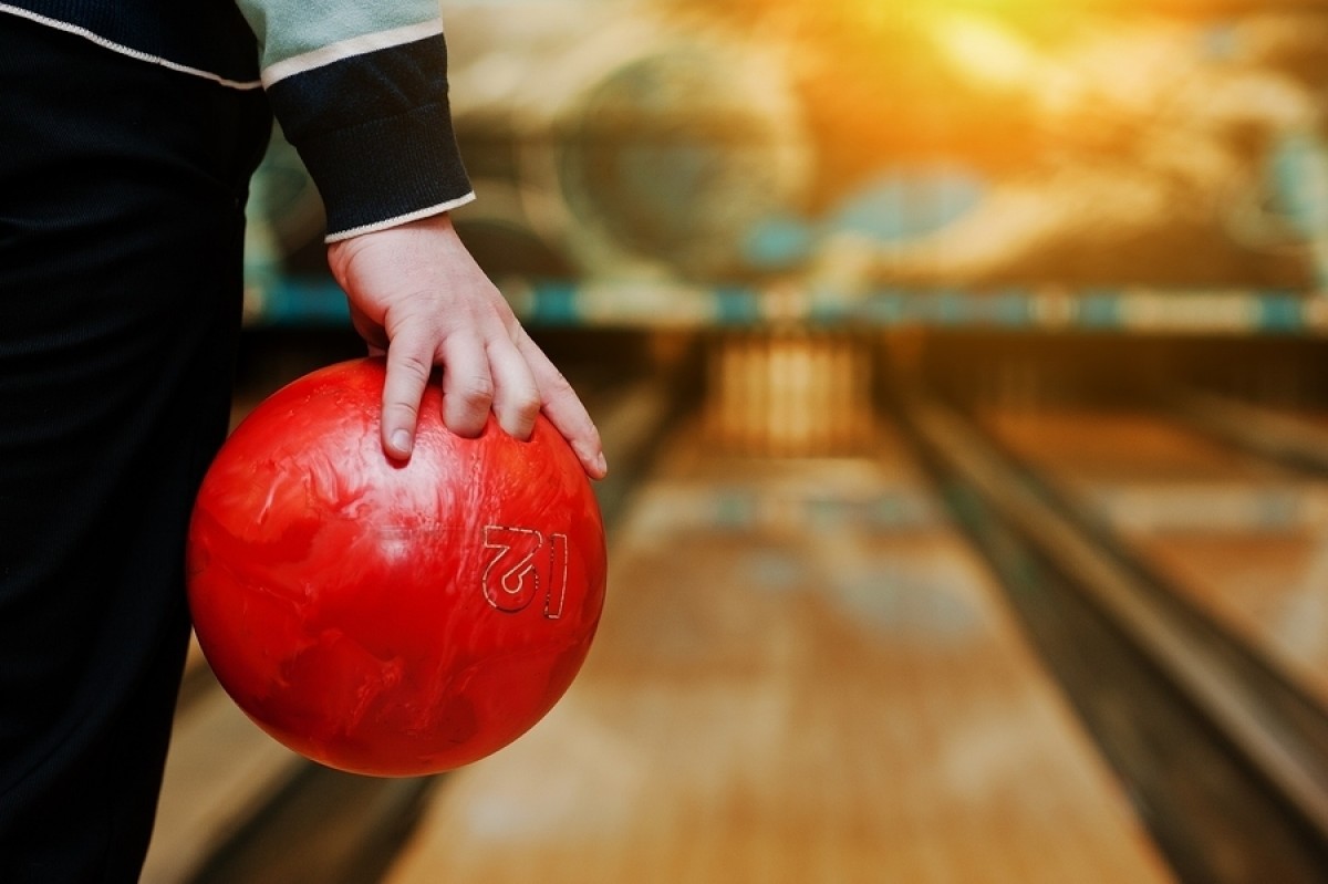 A person getting ready to throw a bowling ball