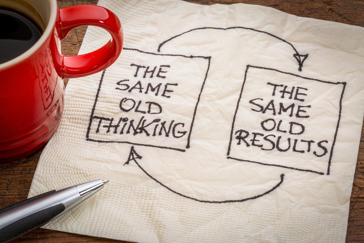Two boxes drawn on a napkin pointing at each other with arrows. One says "The same old thinking" the other box says "The same old results"