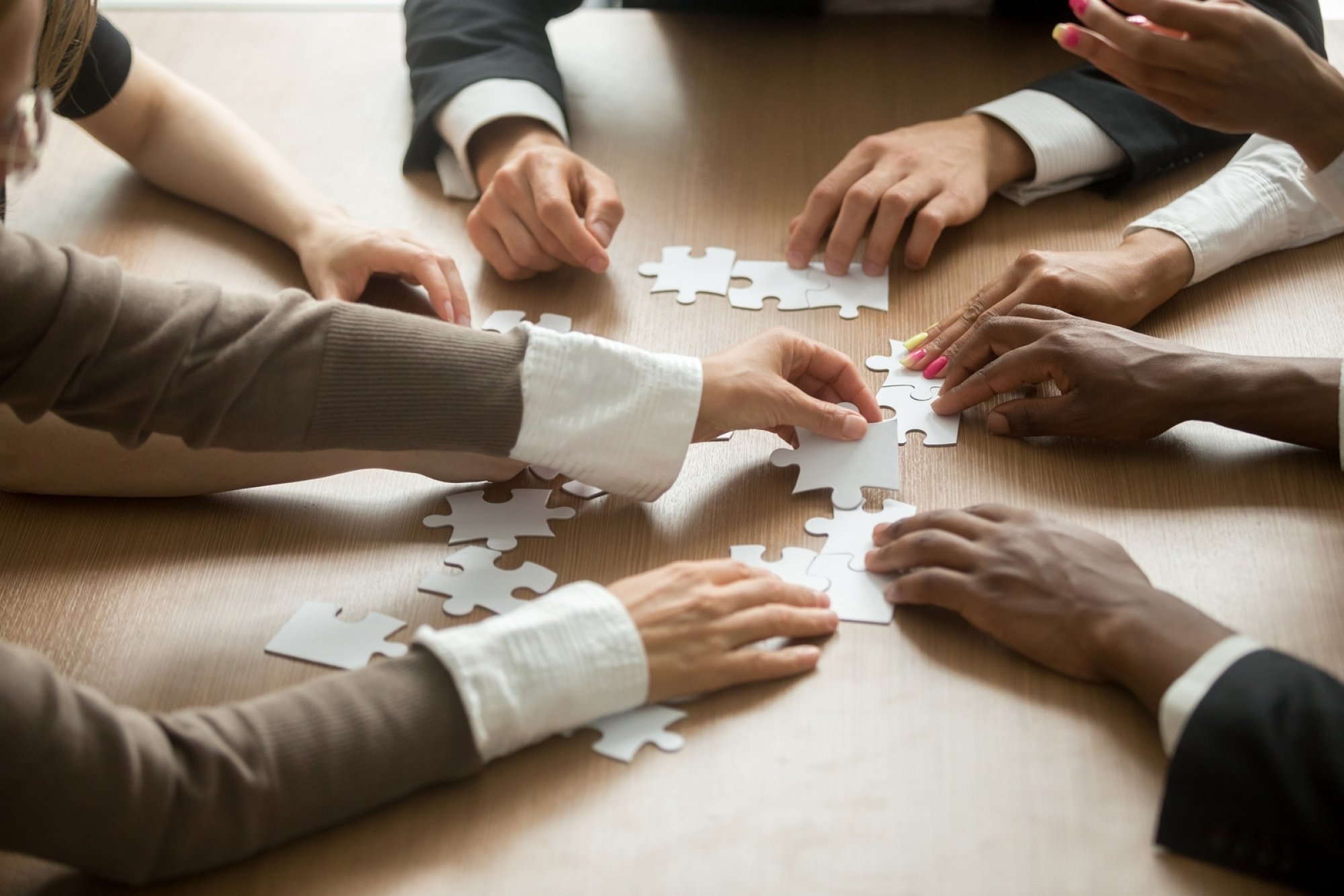 Business people co creating puzzle