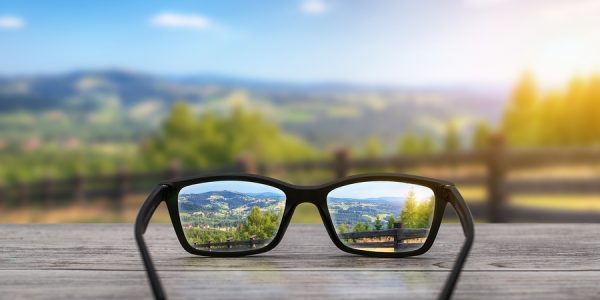 Seeing through the lenses of a pair of glasses resting on a table